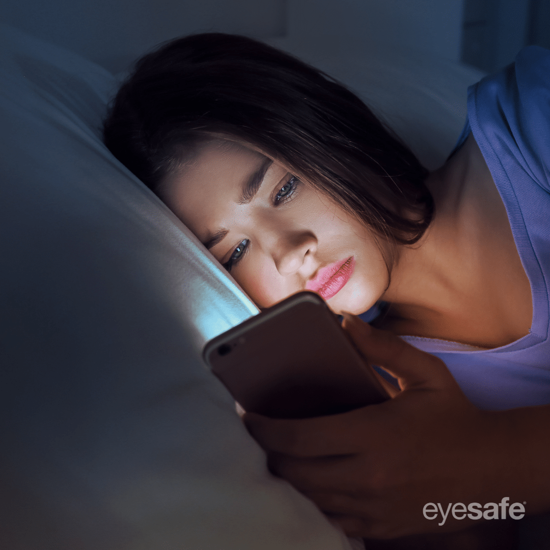 girl looking at her phone in bed