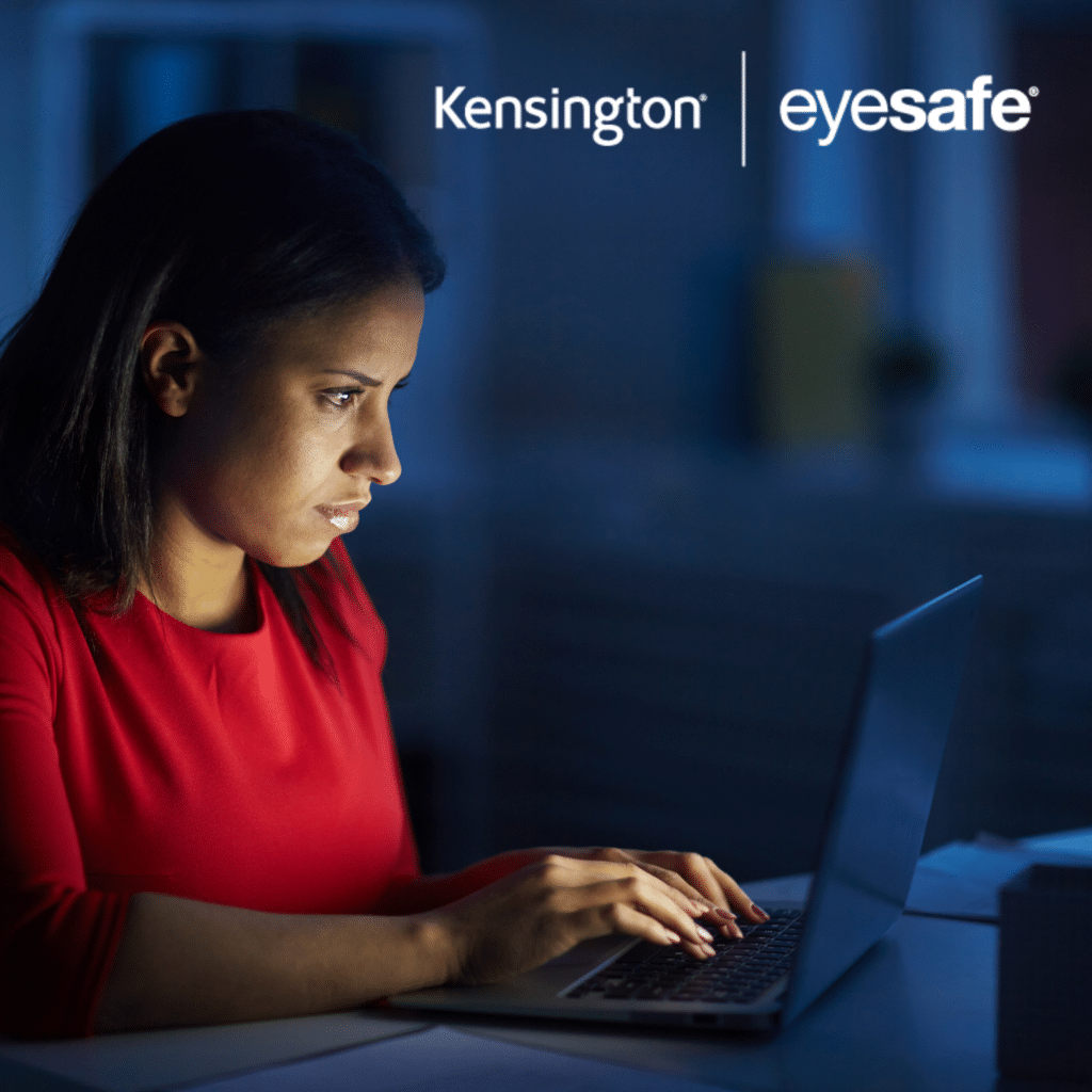 Woman in dark room on a laptop with Kensington | Eyesafe logo.