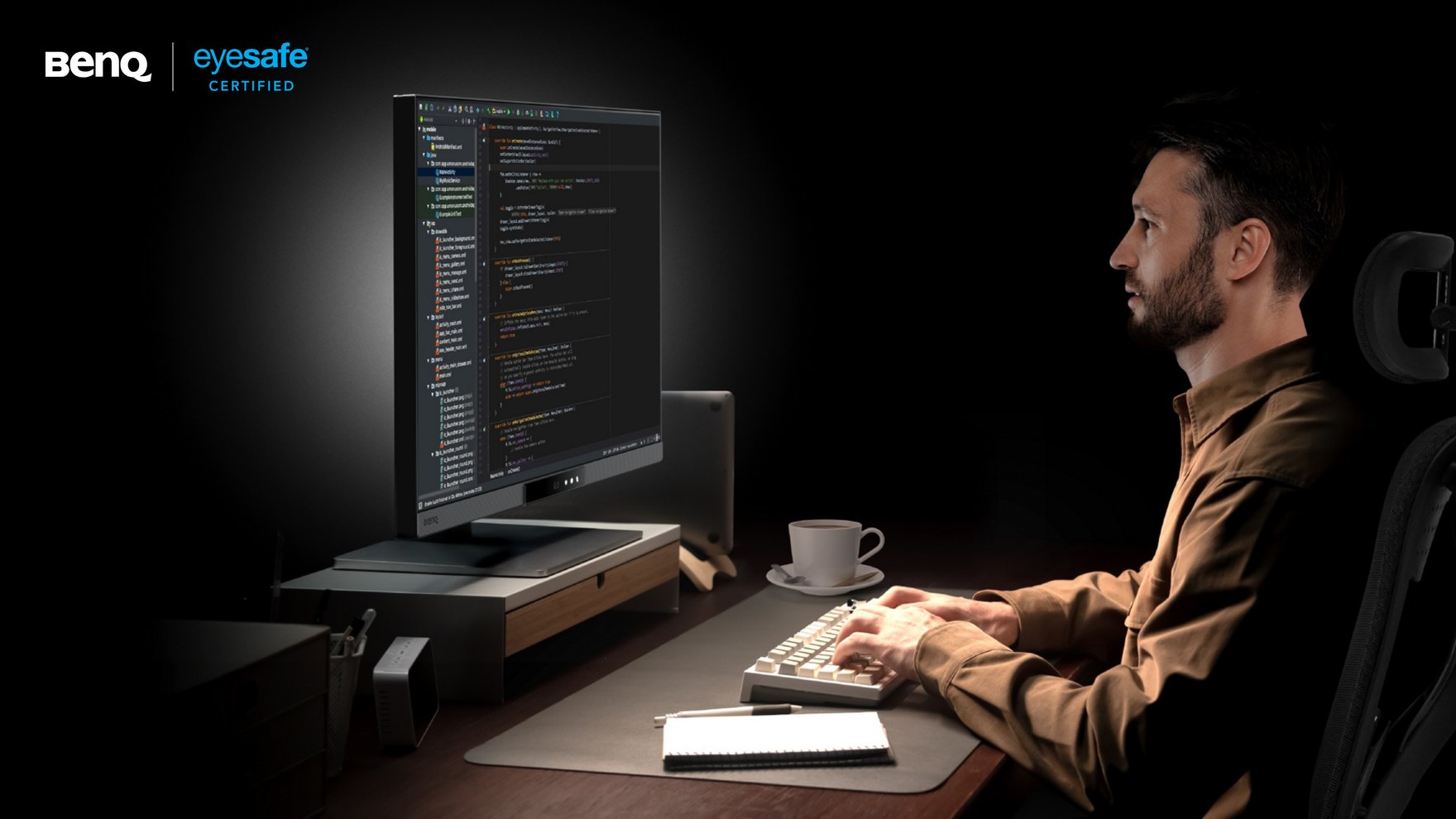 A developer codes late at night at a BenQ RD280UG programming monitor, with the BenQ and Eyesafe Certified marks